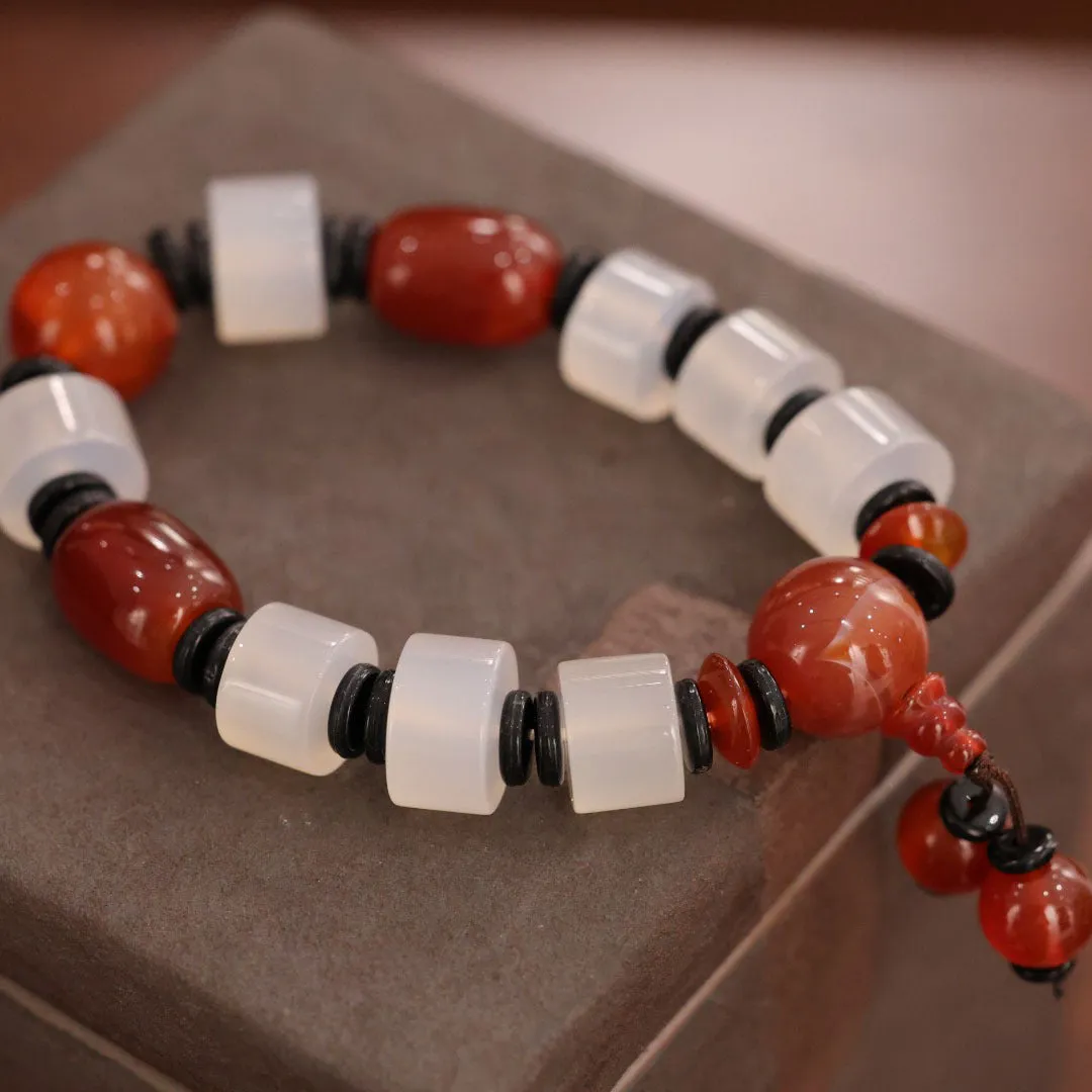 Old agate bracelet with A13 sardonyx bead, white agate spacers, and red agate barrel bead in geometric ethnic design