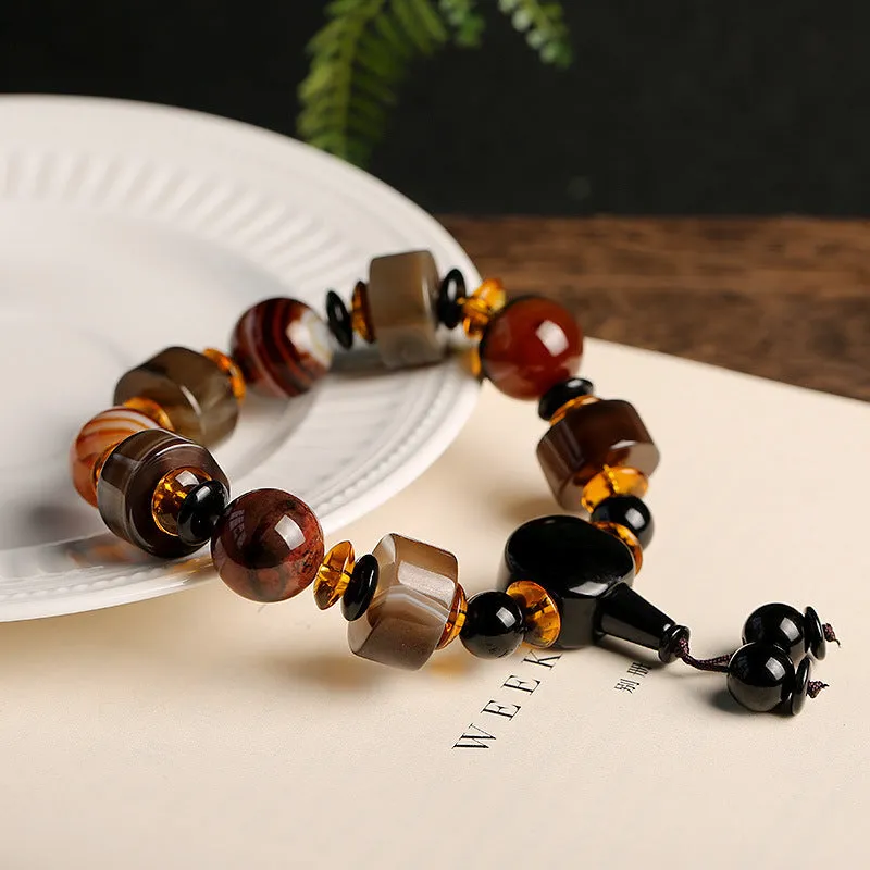 Old agate bracelet with A13 sardonyx bead, white agate spacers, and red agate barrel bead in geometric ethnic design