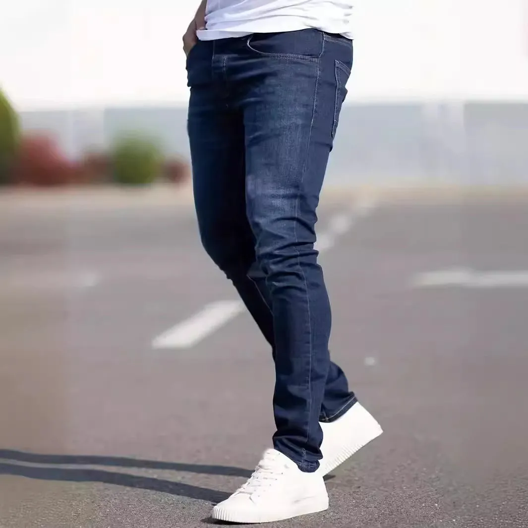 Men's dark blue slim-fit skinny jeans on a hanger, showing mid-waist and zipper fly detail.