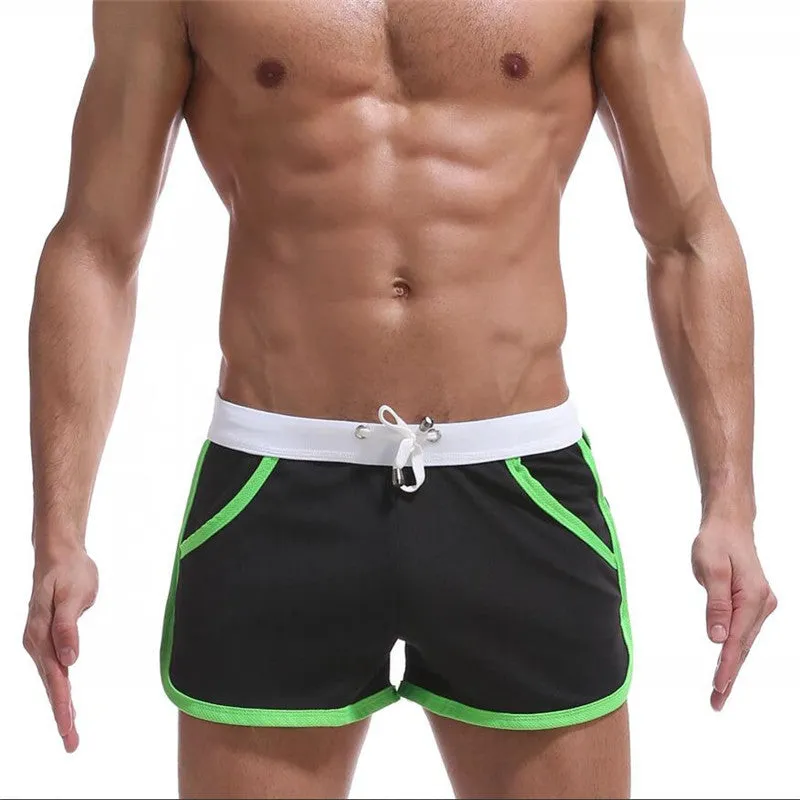 Summer men's quick-dry polyester sports shorts in multiple colours including black, green, and red for beach and casual wear.