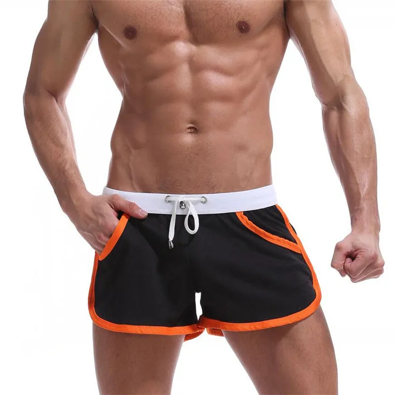 Summer men's quick-dry polyester sports shorts in multiple colours including black, green, and red for beach and casual wear.