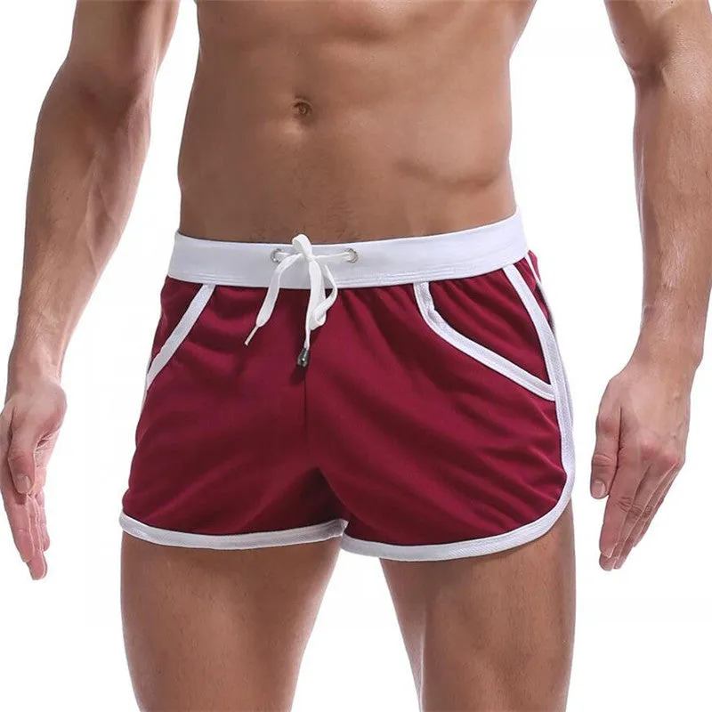 Summer men's quick-dry polyester sports shorts in multiple colours including black, green, and red for beach and casual wear.
