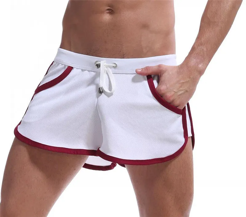 Summer men's quick-dry polyester sports shorts in multiple colours including black, green, and red for beach and casual wear.