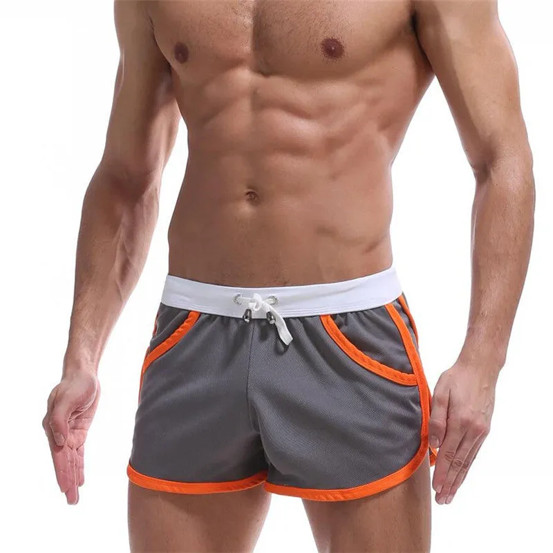 Summer men's quick-dry polyester sports shorts in multiple colours including black, green, and red for beach and casual wear.