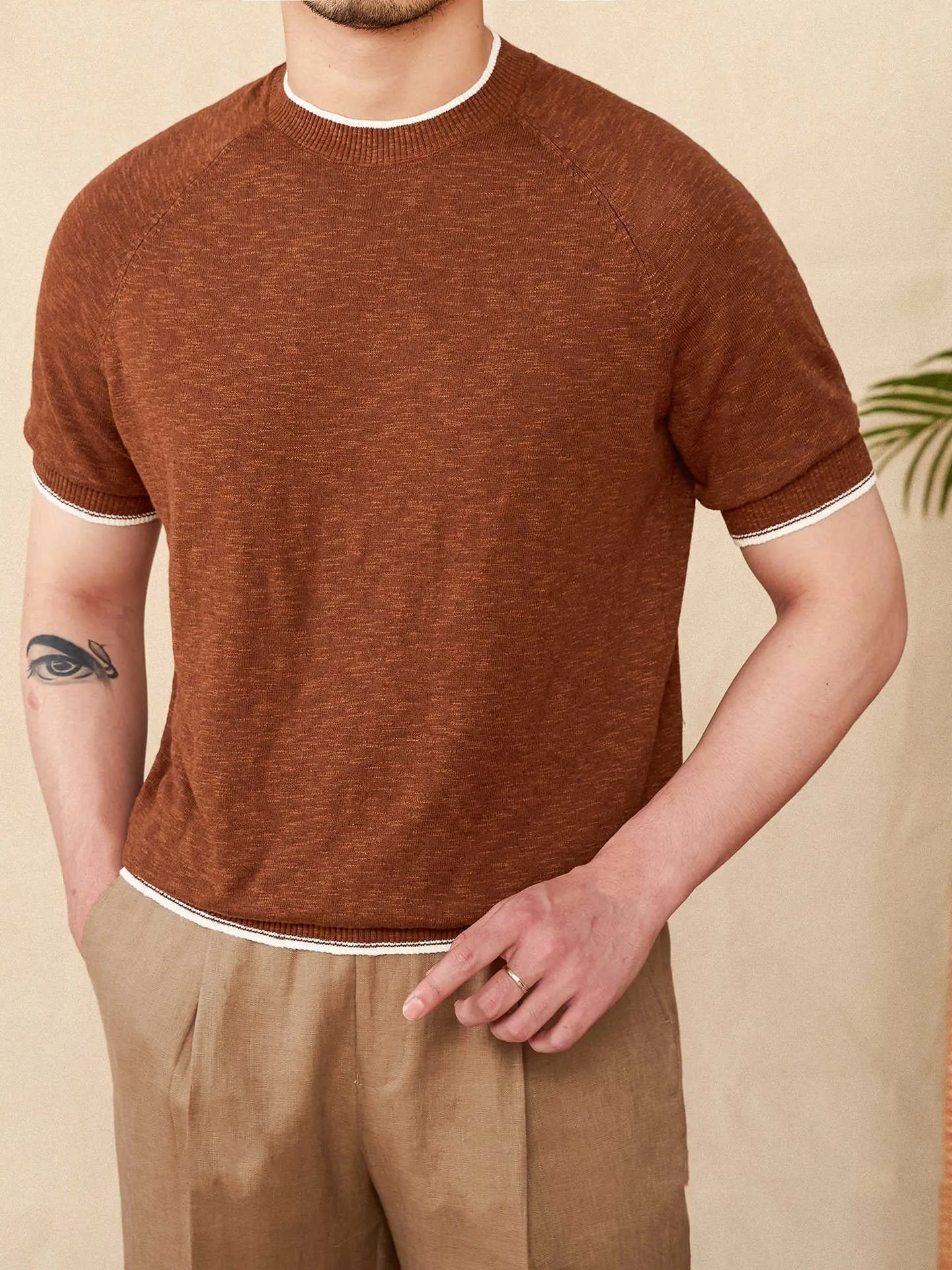 Brown linen cotton casual t-shirt with round neck and short sleeves on hanger