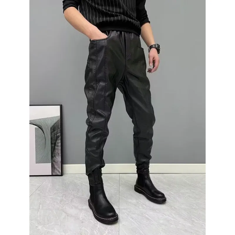 Black PU leather motorcycle takeaway pants with cuffs, tapered leg, and mid-rise waist, on a model