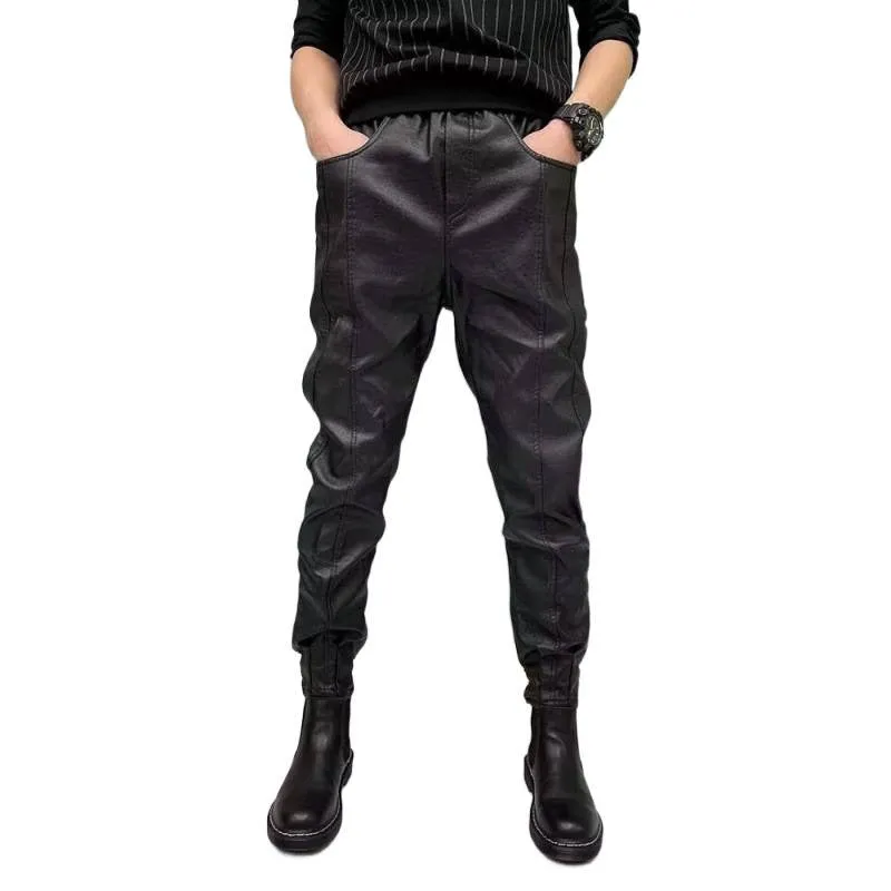 Black PU leather motorcycle takeaway pants with cuffs, tapered leg, and mid-rise waist, on a model