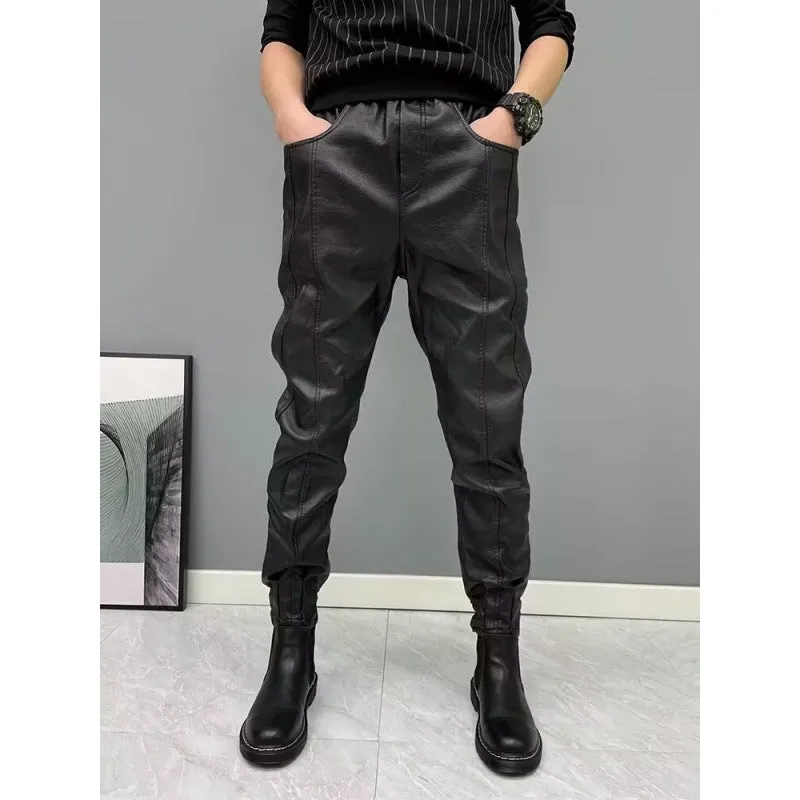 Black PU leather motorcycle takeaway pants with cuffs, tapered leg, and mid-rise waist, on a model