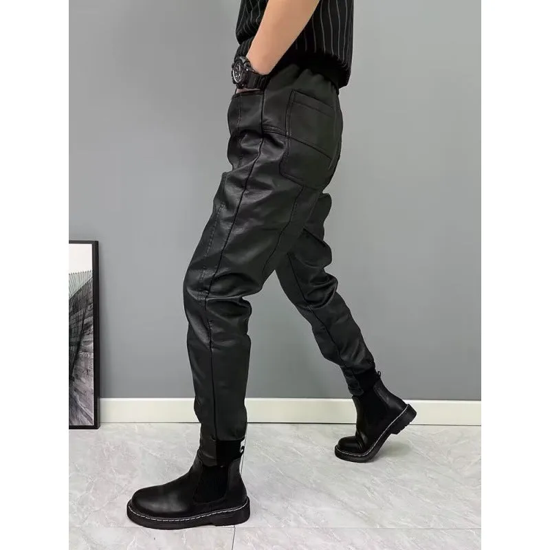 Black PU leather motorcycle takeaway pants with cuffs, tapered leg, and mid-rise waist, on a model