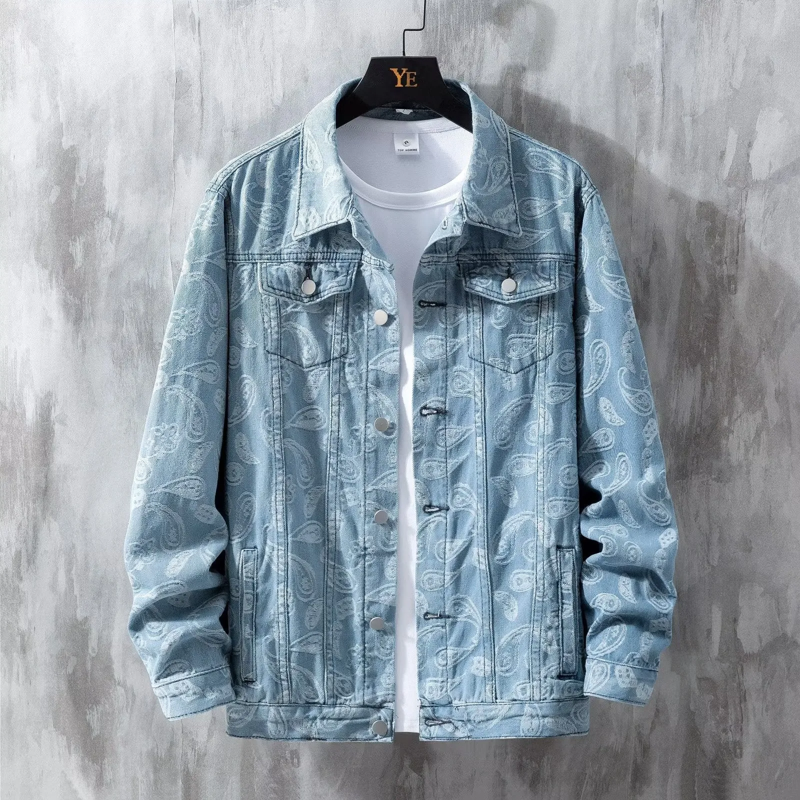 A slim fit men's denim coat in street fashion style, shown in a light blue colour with patch pockets.