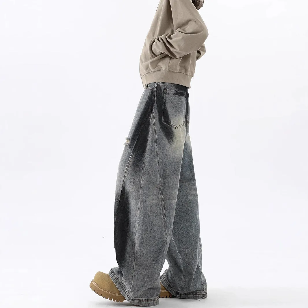 Men's blue distressed jeans with splash-ink patterns and rips in loose fit American style