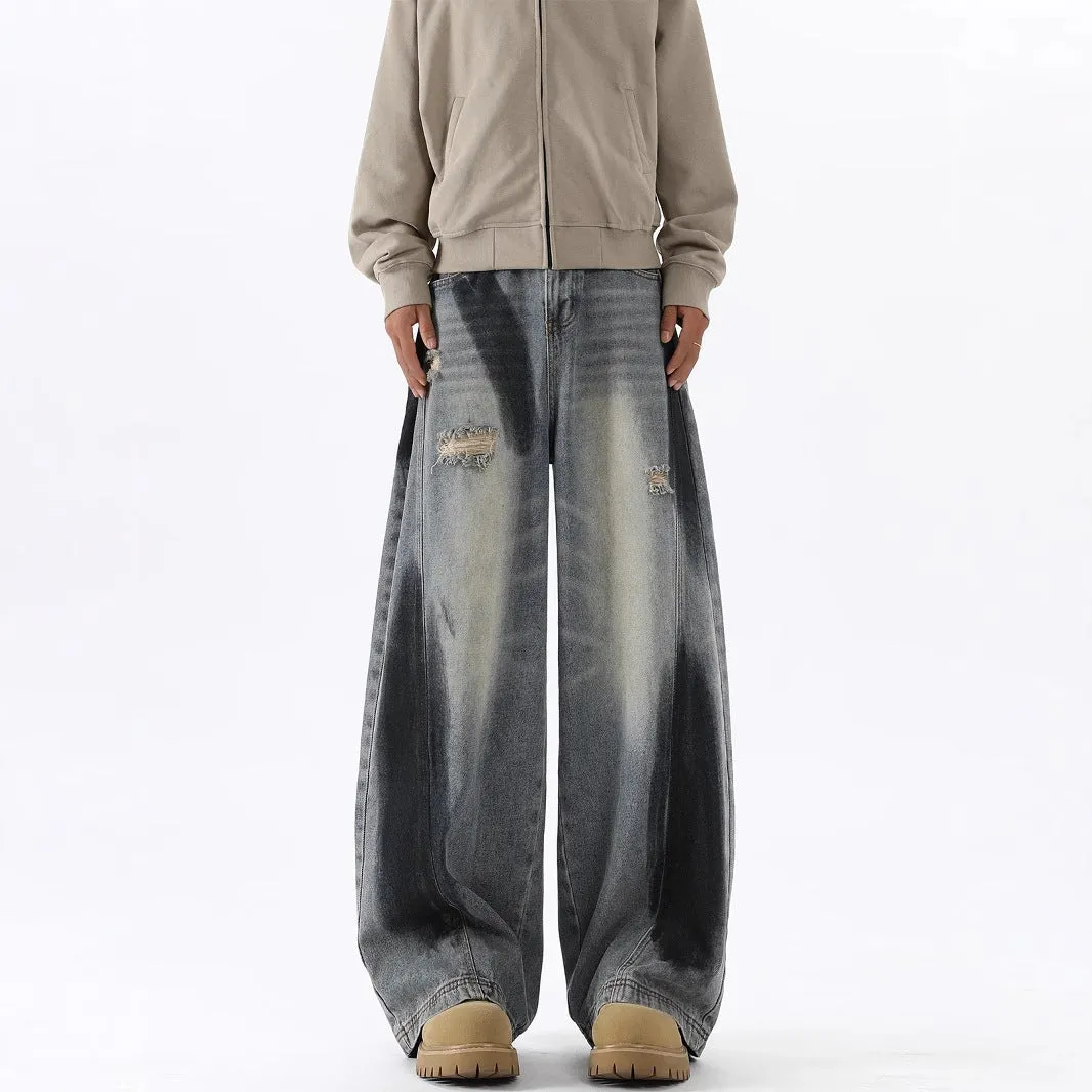 Men's blue distressed jeans with splash-ink patterns and rips in loose fit American style