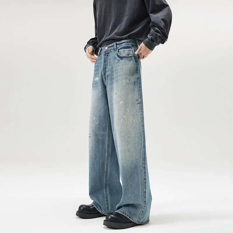 Men's loose fit splash-ink washed denim jeans in Ice Blue on a model, front view