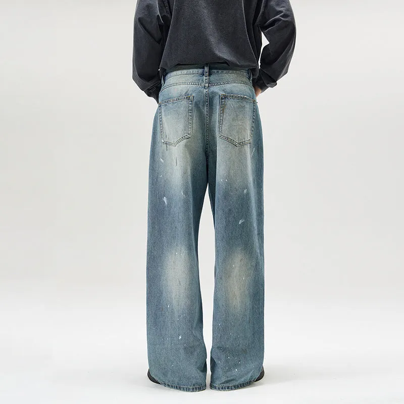 Men's loose fit splash-ink washed denim jeans in Ice Blue on a model, front view