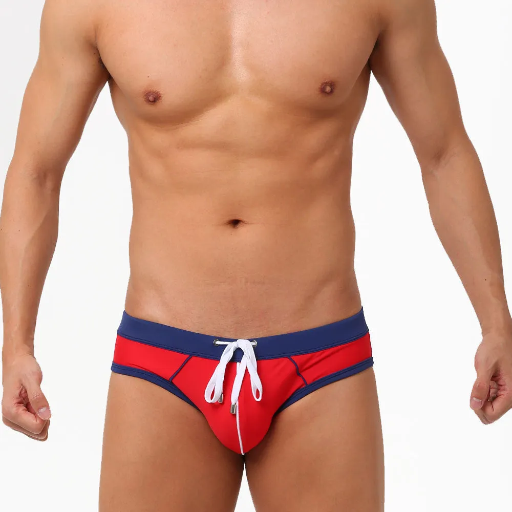Nylon men's swim briefs in orange colour with elastic waistband, front view