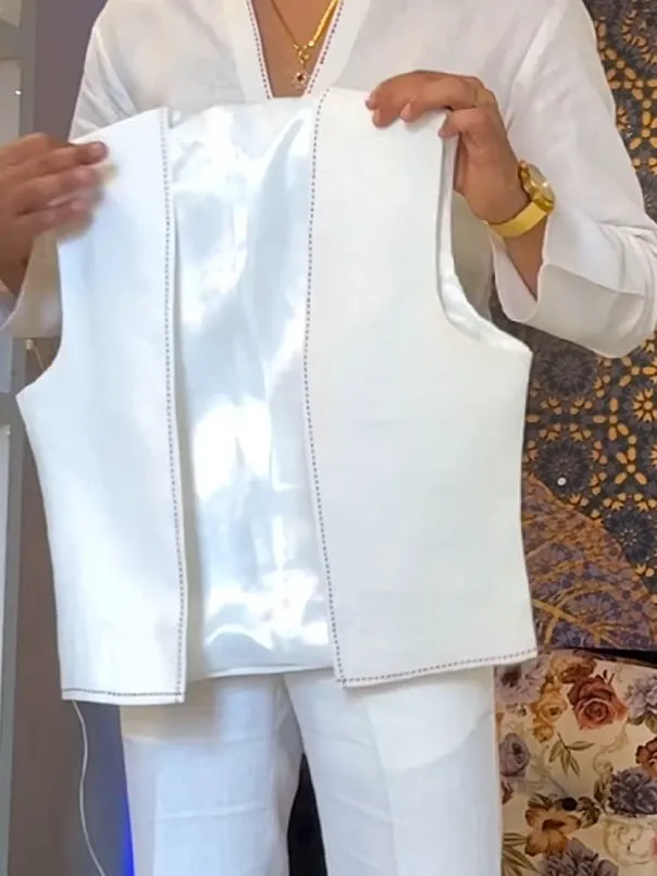 White three-piece women's outfit with V-neck shirt, sleeveless vest, and full-length trousers