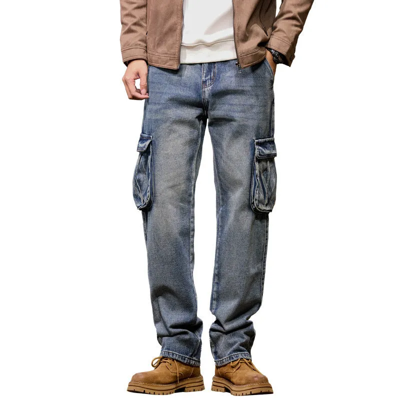 Man wearing loose-fit blue denim hip hop trousers with multiple pockets and a straight leg.