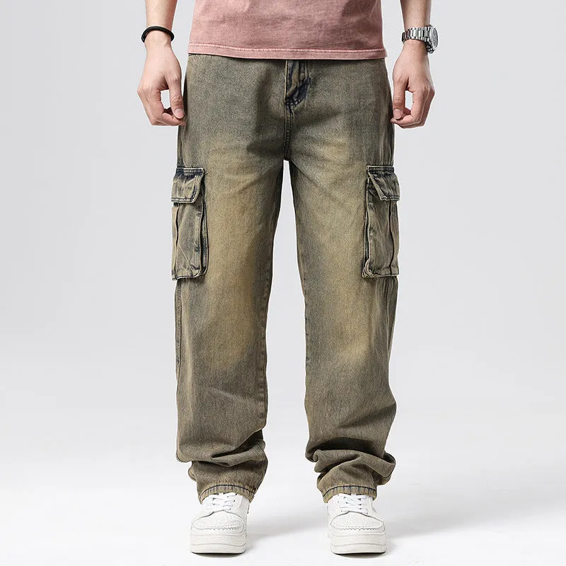 Man wearing loose-fit blue denim hip hop trousers with multiple pockets and a straight leg.