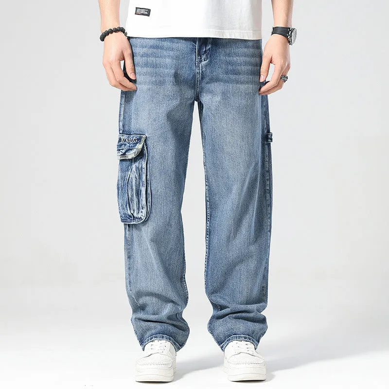 Man wearing loose-fit blue denim hip hop trousers with multiple pockets and a straight leg.