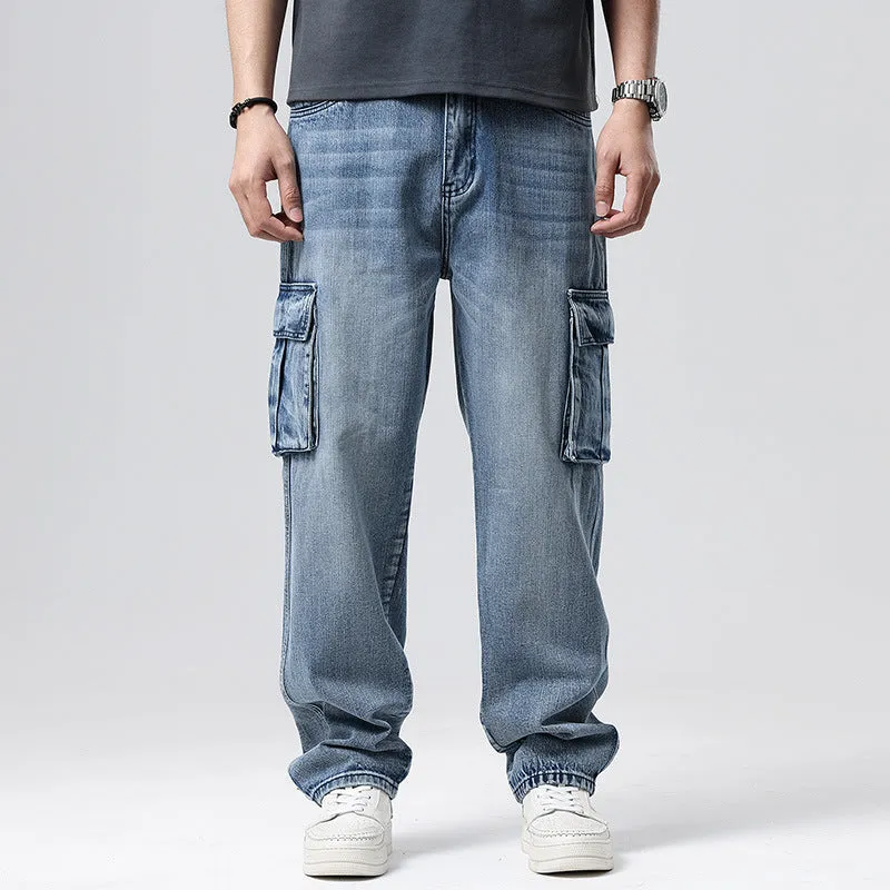 Man wearing loose-fit blue denim hip hop trousers with multiple pockets and a straight leg.