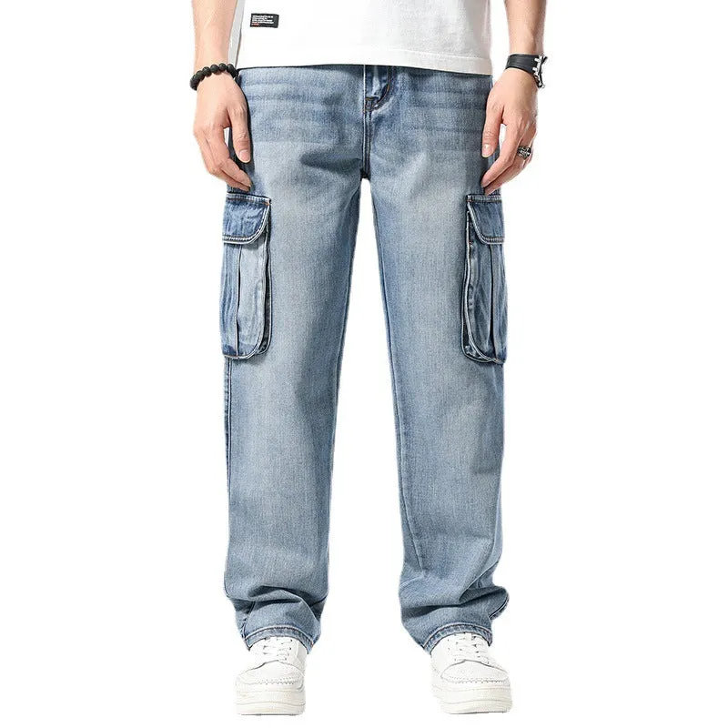 Man wearing loose-fit blue denim hip hop trousers with multiple pockets and a straight leg.
