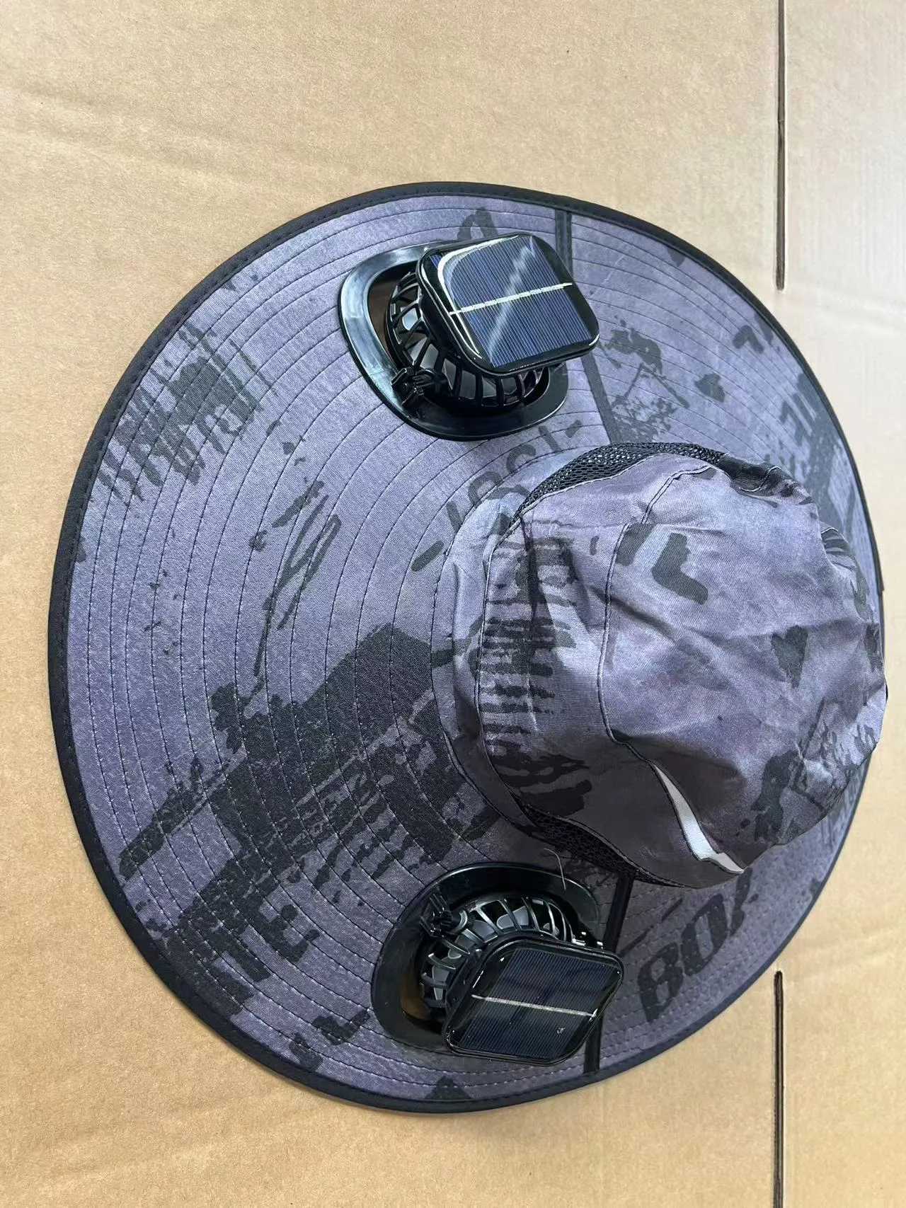 Men's grey solar fan cap with large shading eave and integrated cooling fan on brim.