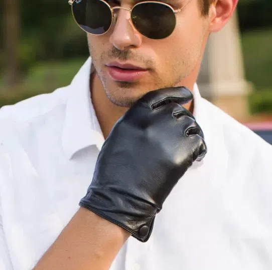 Black touch leather motorcycle driving gloves on a surface, size S to XXL available, unlined single-layer design