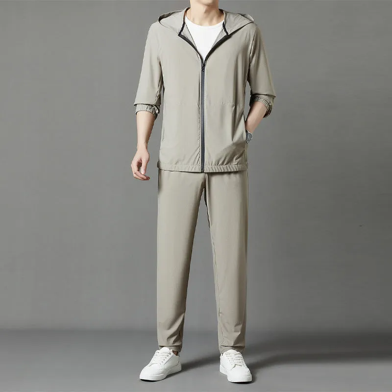 Grey hooded sun-protective top and trousers casual set laid flat showing loose fit and pocket detail