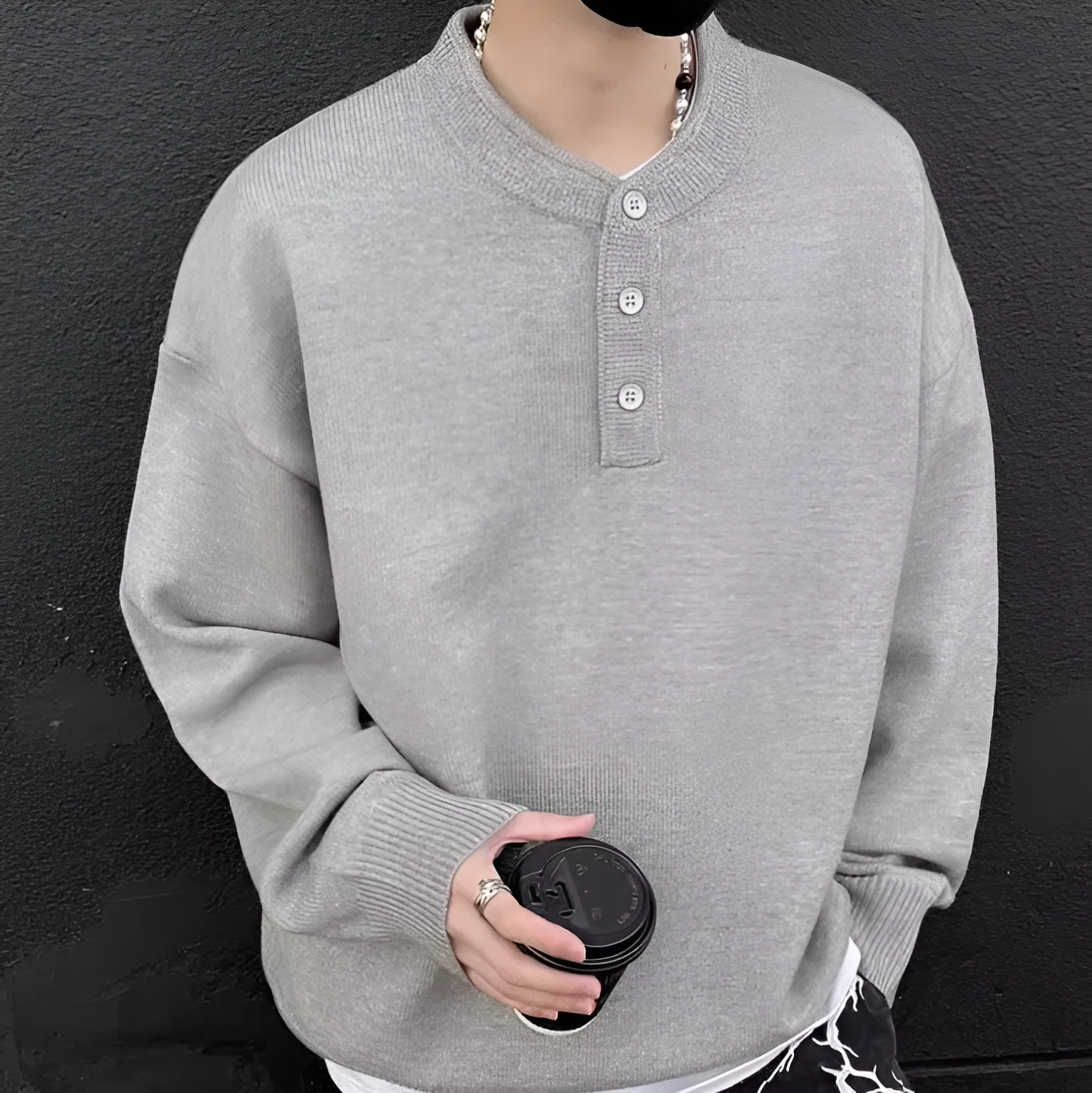 Men's loose Hong Kong style long sleeve polyester knit sweater in black, front view on model