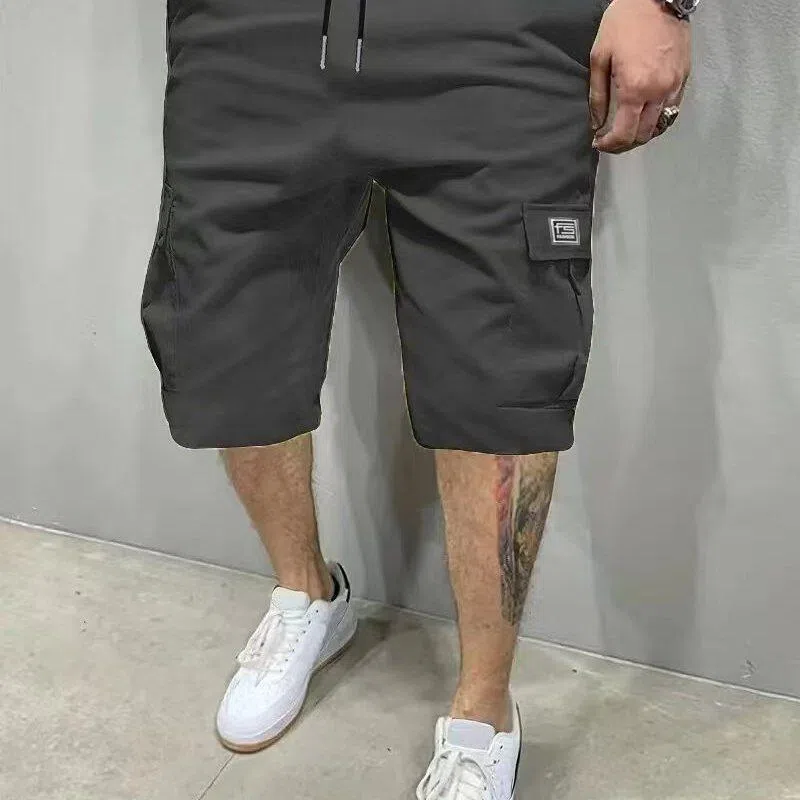 Men's polyester straight-leg shorts in black showing side pocket and waistband detail