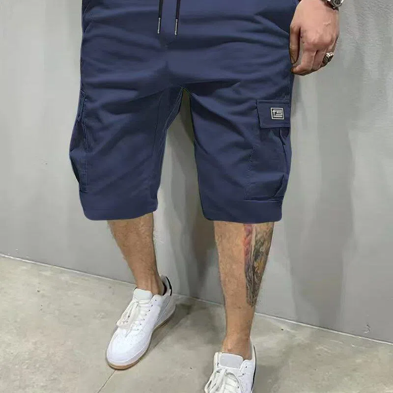 Men's polyester straight-leg shorts in black showing side pocket and waistband detail