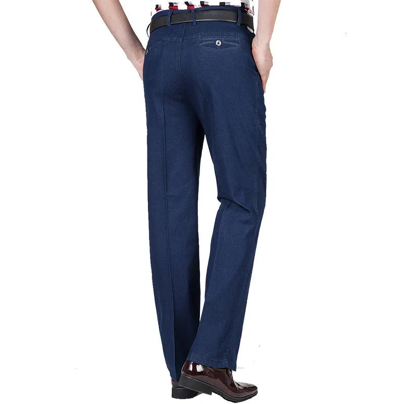 Men's loose fit high waist blue denim jeans on a plain background.