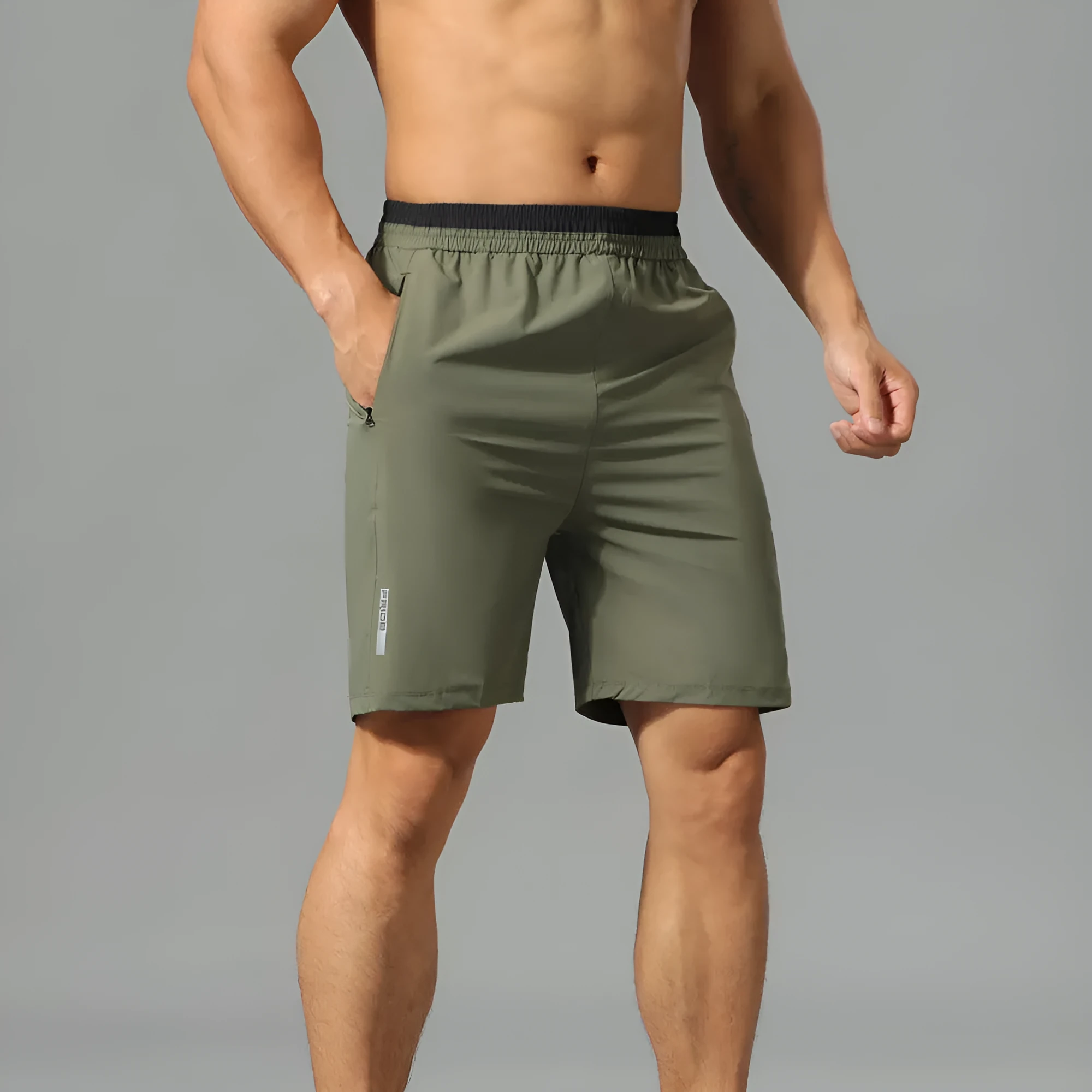 Man wearing grey loose-fit cropped Ice Silk pants for running or leisure.