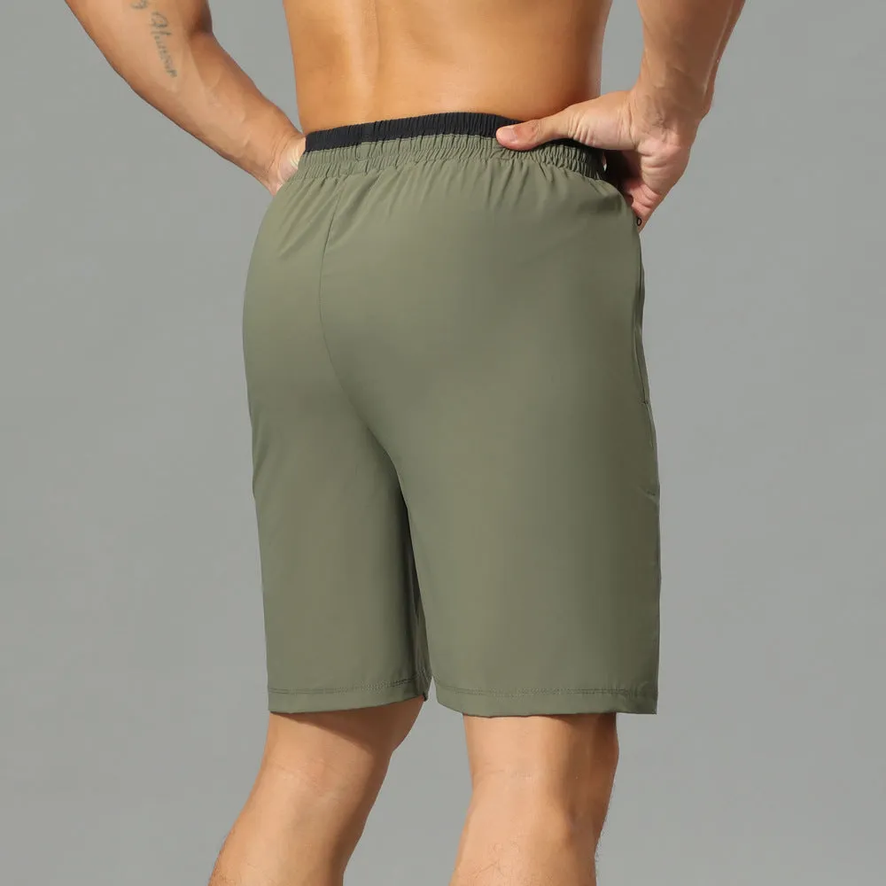 Man wearing grey loose-fit cropped Ice Silk pants for running or leisure.