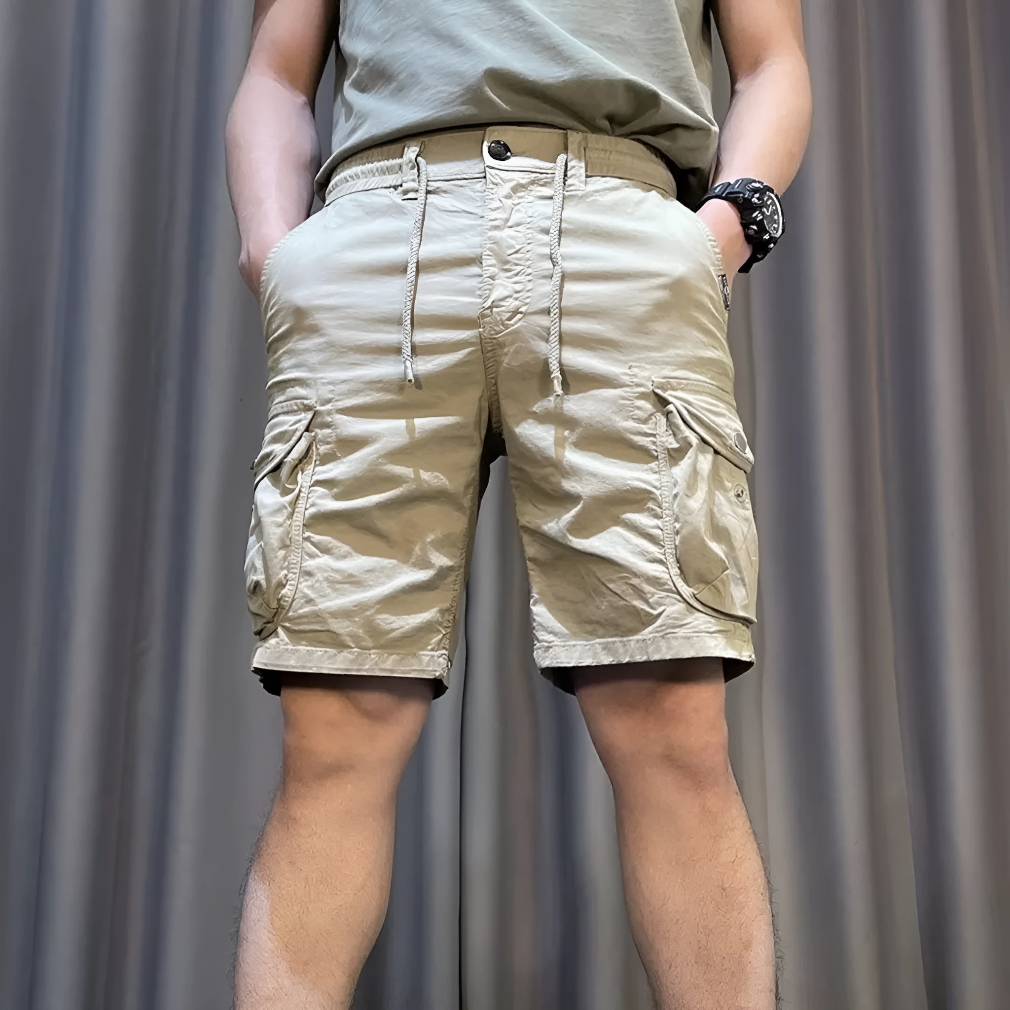 Man wearing loose straight-leg khaki overalls with multiple pockets, showcasing the Korean-style relaxed fit.