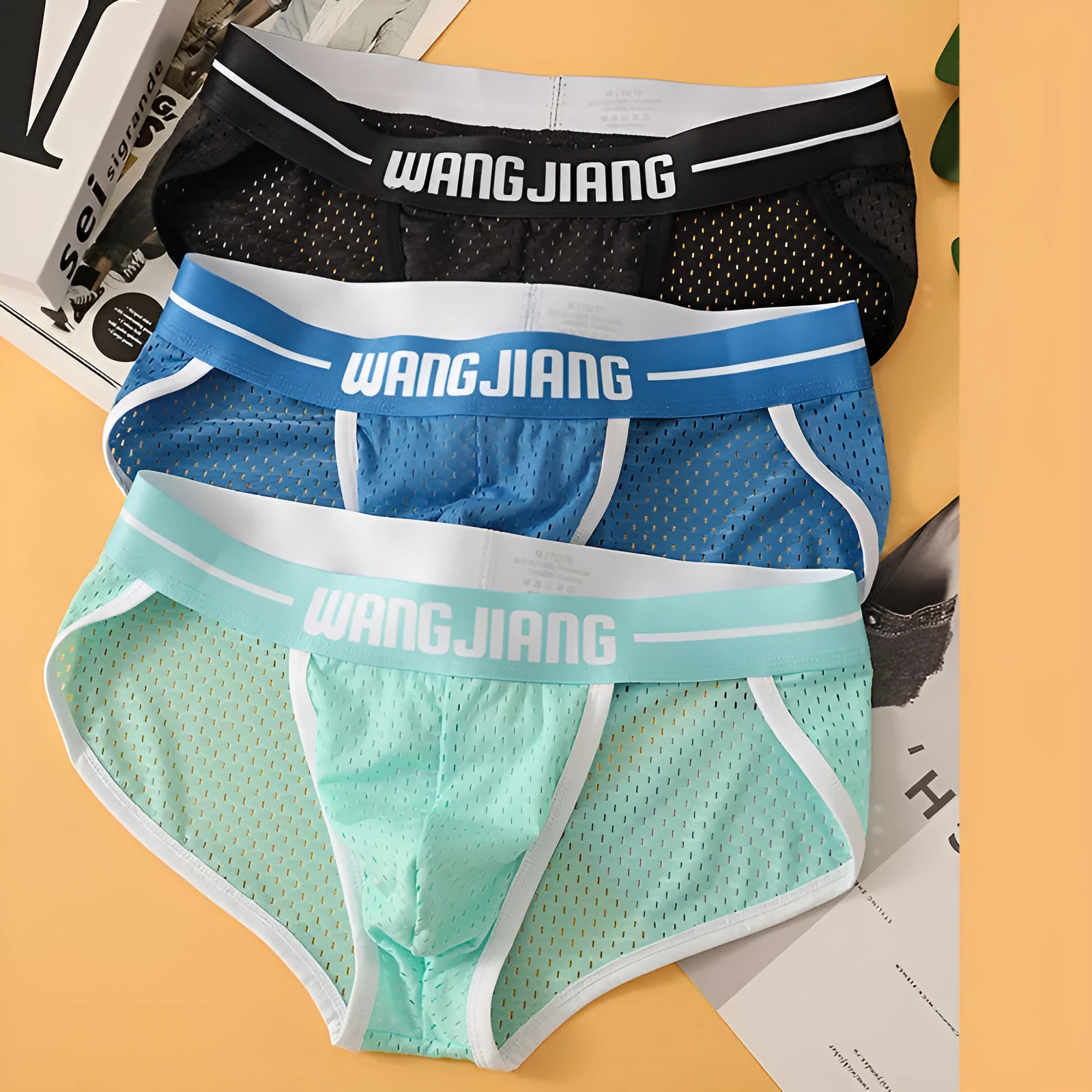Men's black Ice Silk triangle briefs with mesh breathable fabric on a solid background.