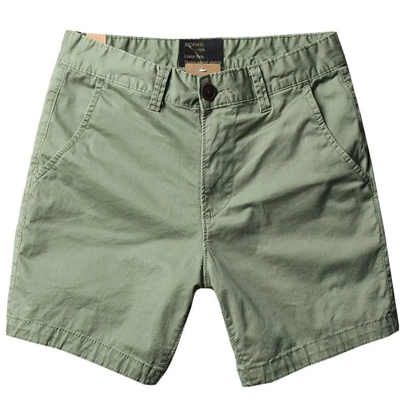 Men's loose straight-leg cotton shorts in solid colours on a hanger