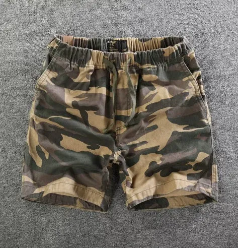 Men's loose straight-leg cotton shorts in solid colours on a hanger