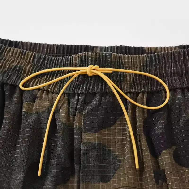 Man's green H215 camouflage cotton work shorts with multiple pockets shown in a loose fit.