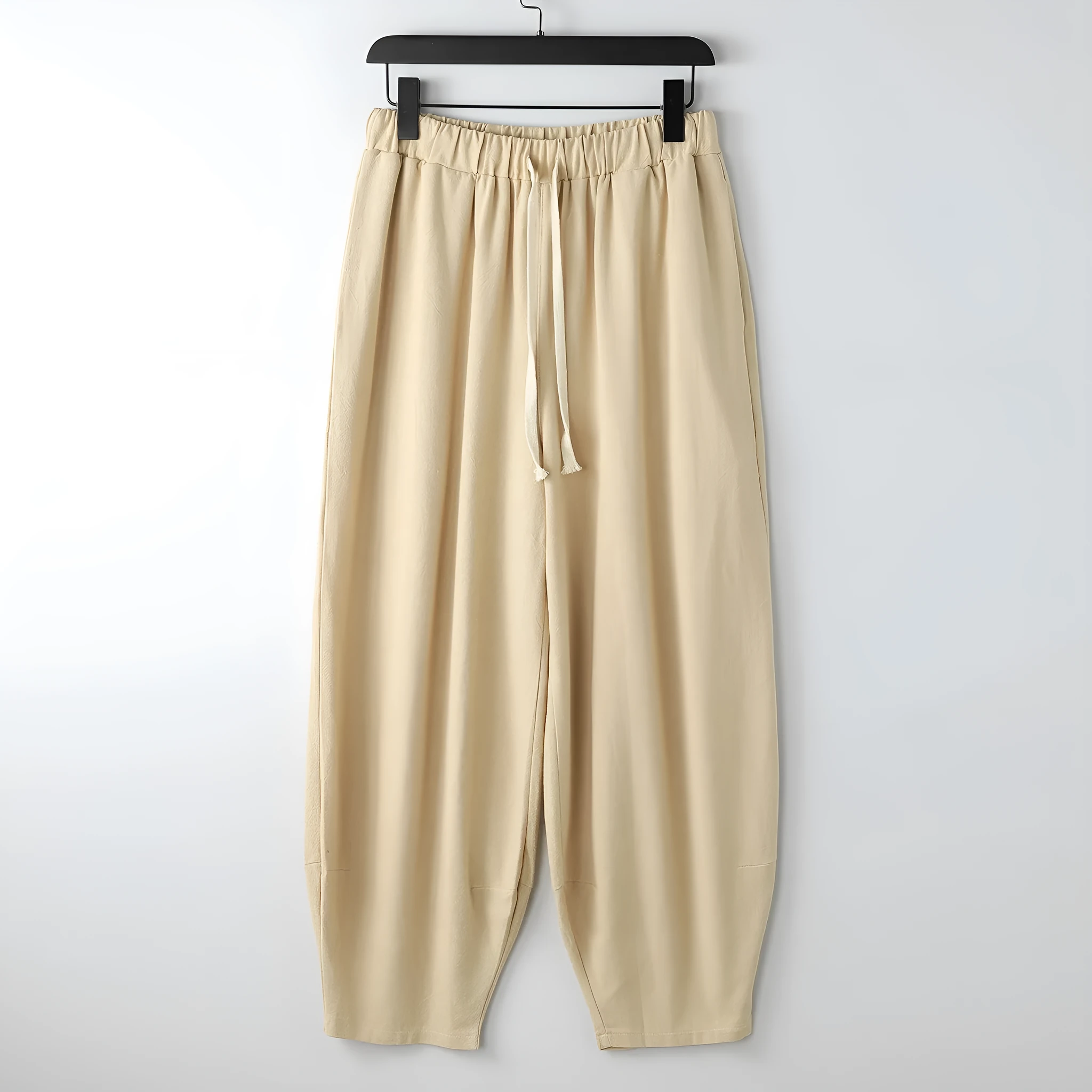 Linen harem pants for men with loose tapered fit and ankle-tied cuffs, shown in grey.