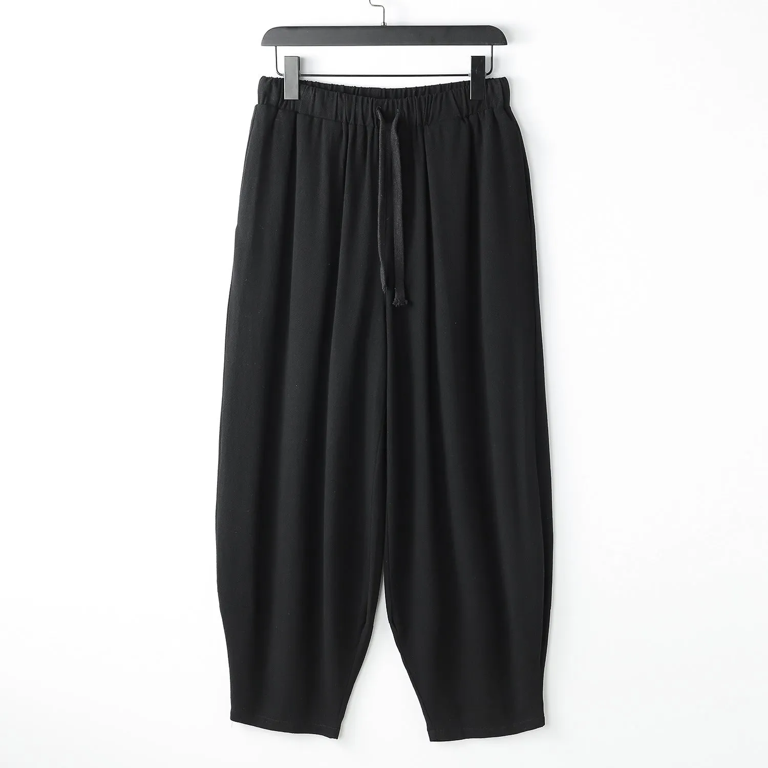 Linen harem pants for men with loose tapered fit and ankle-tied cuffs, shown in grey.