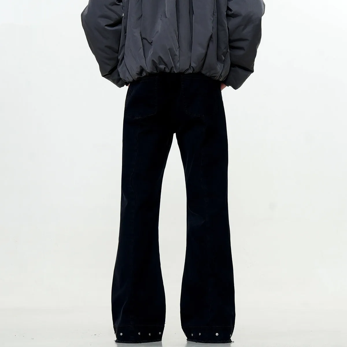 Straight-leg cotton jeans on a hanger, showing mid-waist fit, zipper fly, and horn-style leg opening.