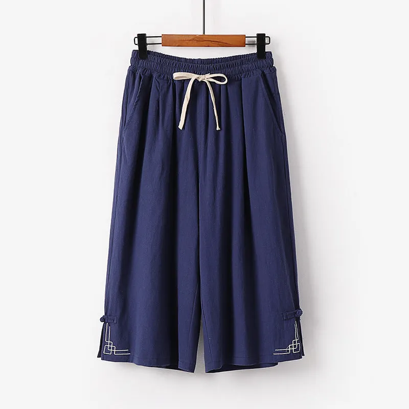 Women's wide leg linen leisure shorts in apricot colour with embroidery detail.