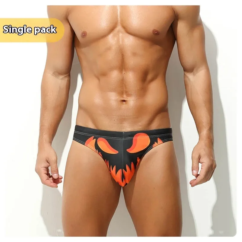 Man wearing grey low waisted digital print polyester shorts, showcasing the briefs fit and graphic design.