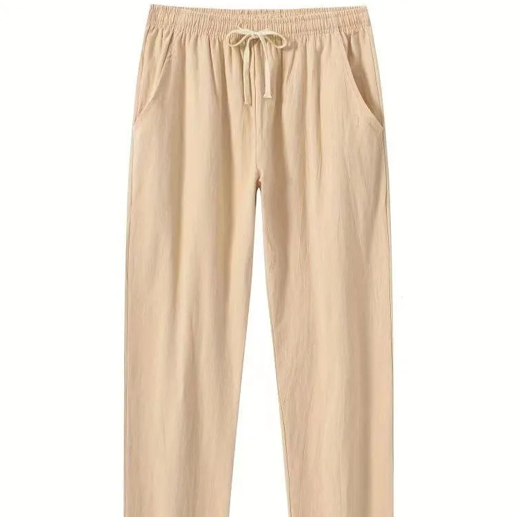 Men's loose-fitting cotton beach pants in khaki colour on a casual background.