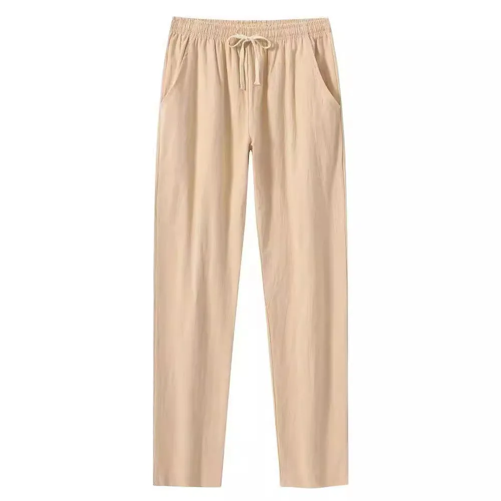 Men's loose-fitting cotton beach pants in khaki colour on a casual background.