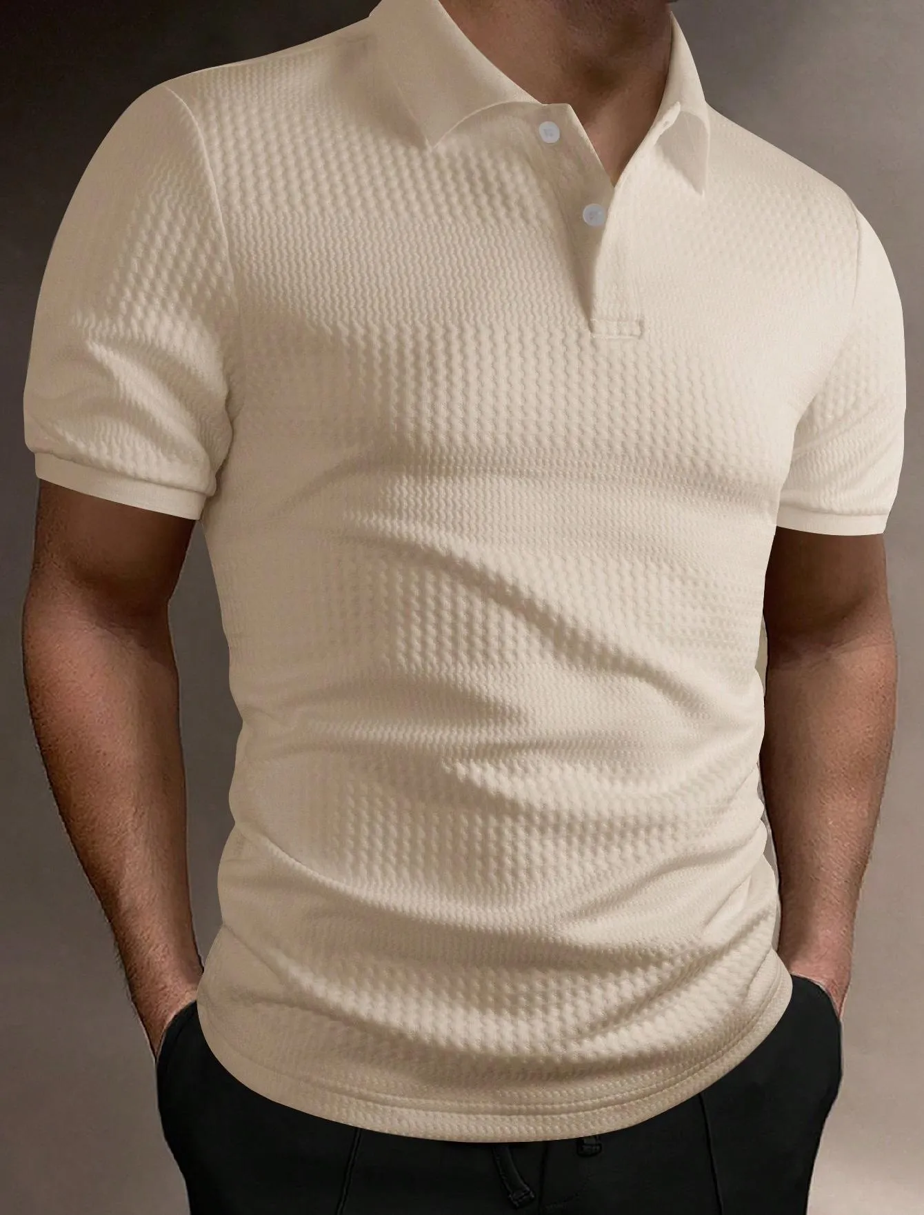 Man wearing a loose fit striped polo shirt in a light blue colour with an asymmetric design detail.
