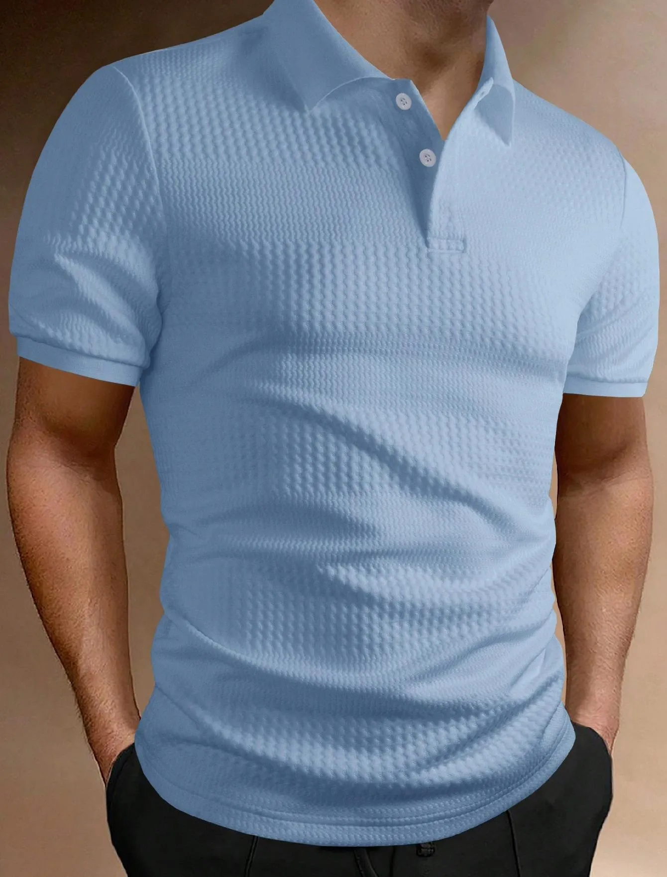 Man wearing a loose fit striped polo shirt in a light blue colour with an asymmetric design detail.
