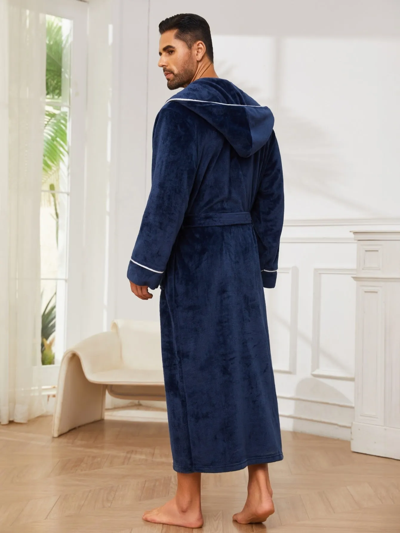 Man wearing a light grey flannel bathrobe in a European style for winter.