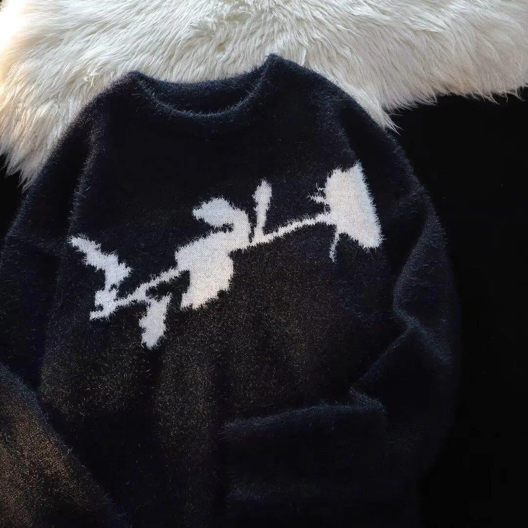 Man wearing a dark grey pullover sweater with a large rose-coloured flocking horse print on the chest.